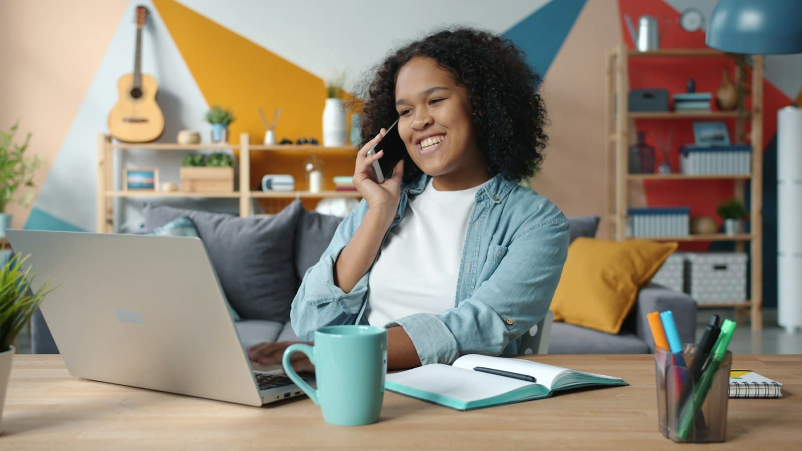 A woman talking on the phone while working at a desk