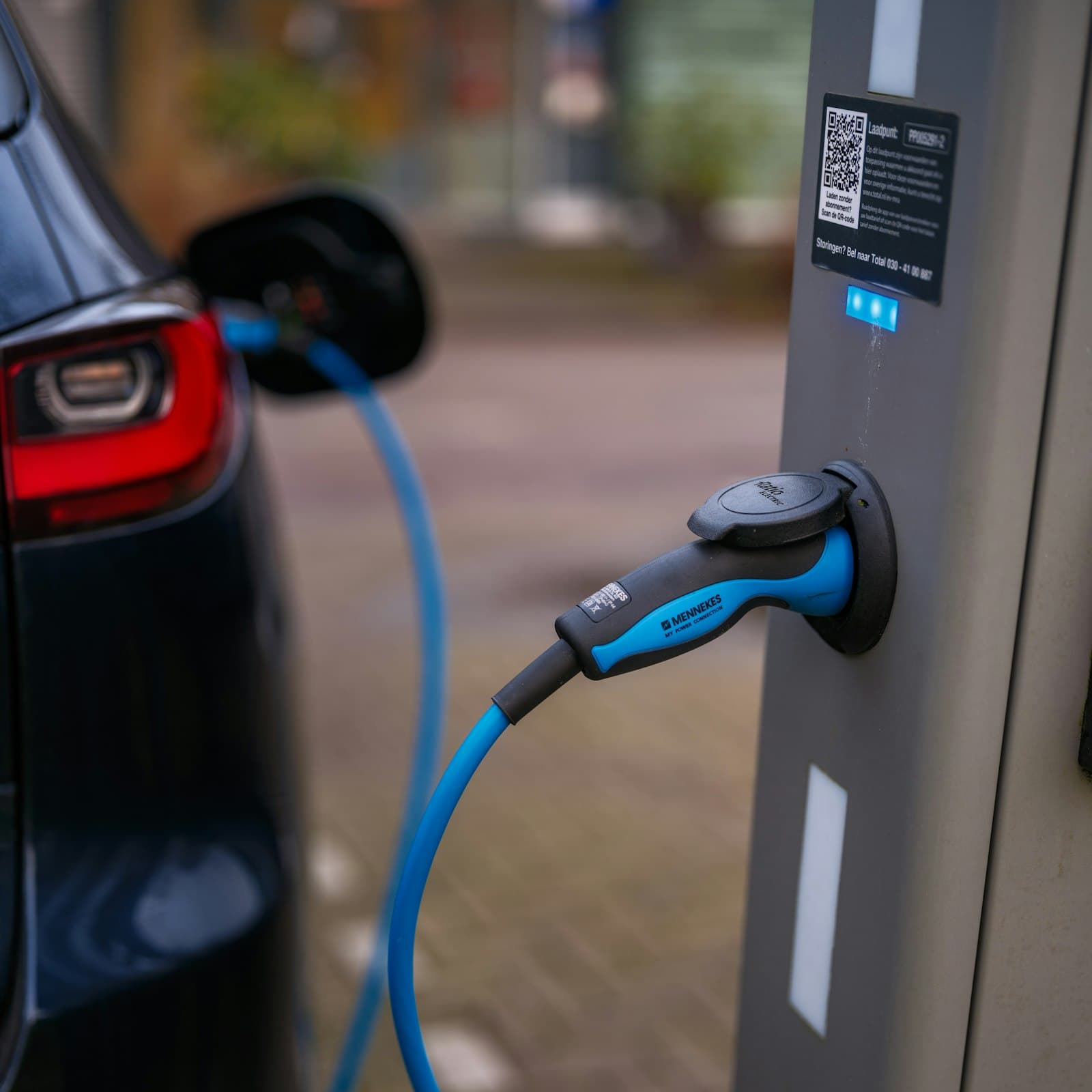 An electric car plugged in to a charging station