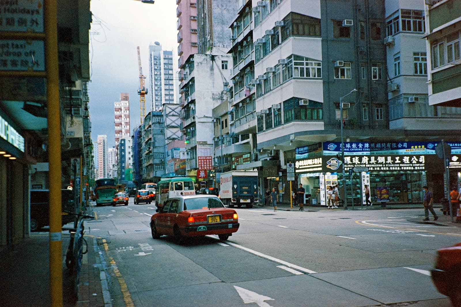 A taxi driving down a busy city street